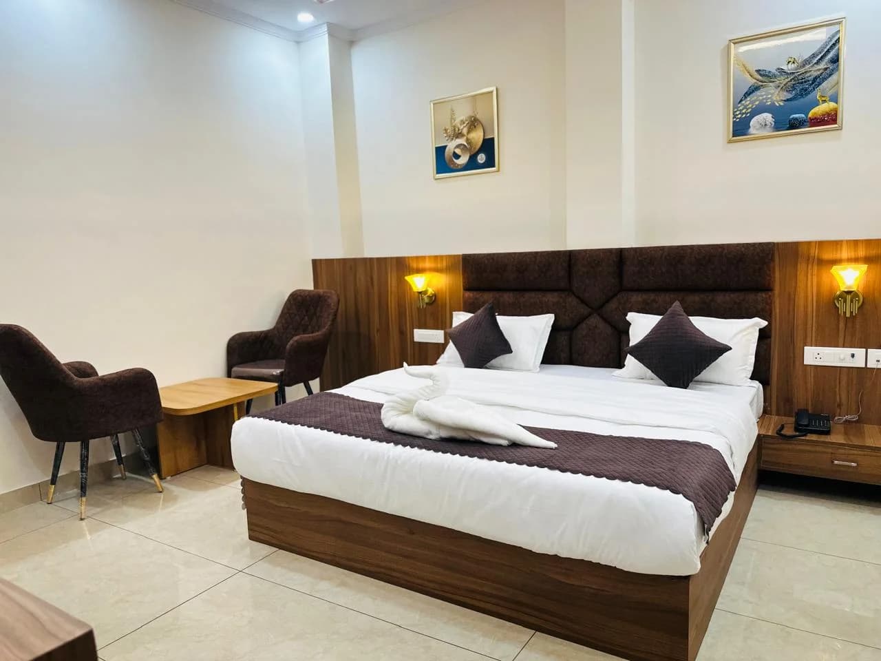 Premium Suite featuring expansive bedroom with modern accent wall and lighting